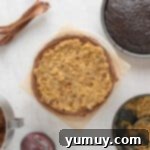 overhead view of a frosted chocolate cake layer with german chocolate filling on top on a cake stand.