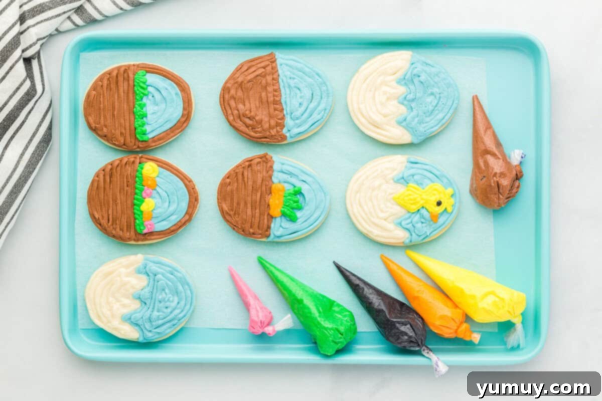 Whimsical Easter Egg Cookies 18 Overhead view of six frosted Easter egg sugar cookies on a blue baking sheet, showing various stages of decoration with colored frostings.