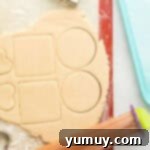 Whimsical Easter Egg Cookies 7 Overhead view of rolled out Easter egg sugar cookie dough, freshly cut into egg shapes.