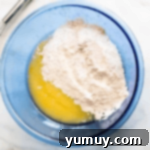 Spiced Carrot Cupcakes with Cream Cheese Frosting 5 cake mix and eggs in a blue bowl.