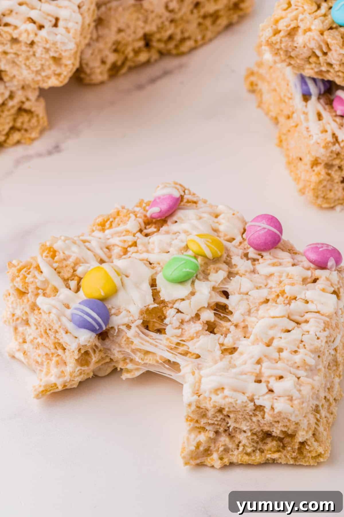 Spring Crispy Delights 3 Pulled apart Easter Rice Krispie Treat showing its gooey texture.