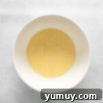 Luscious Blackberry Cupcakes 5 A white bowl with a yellow liquid mixture for the cupcake batter.