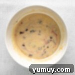 Luscious Blackberry Cupcakes 7 Cupcake batter in a mixing bowl with fresh chopped blackberries folded in.