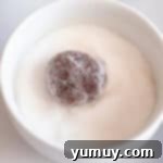 Gooey Chocolate Marshmallow Cookies 11 Cookie dough ball rolled in sugar, ready for baking.