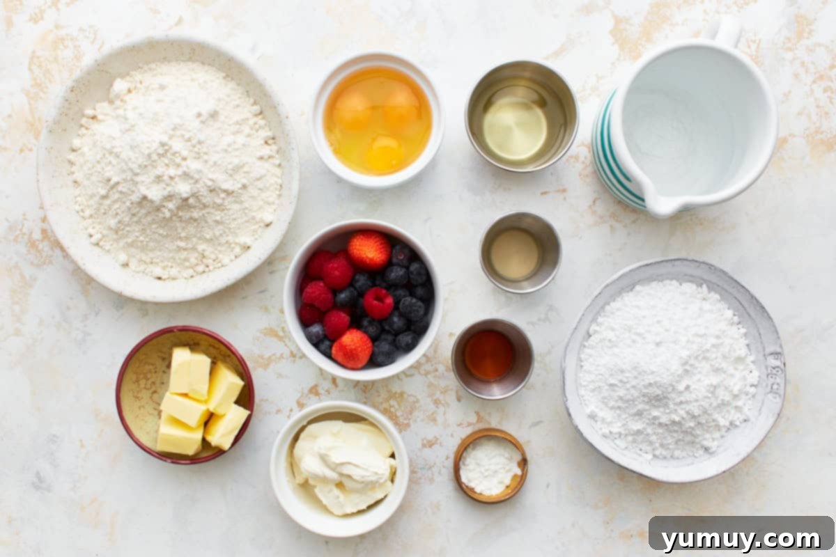 All ingredients for berry-filled cupcakes neatly arranged in dishes, ready for baking.