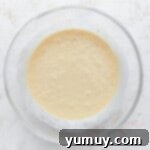 Cupcake batter in a glass mixing bowl.