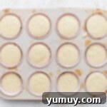 Cupcake tin filled with batter.