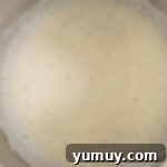 Light & Airy Chocolate Cloud Cake 7 foamy egg whites in a stainless mixing bowl.