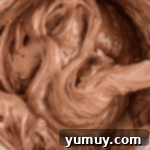 Light & Airy Chocolate Cloud Cake 10 folding chocolate meringue in a stainless mixing bowl.