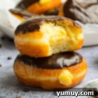 Boston Cream Delights 4 Featured Boston Cream Donuts, perfectly glazed and filled.