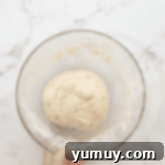 Boston Cream Delights 7 A smooth ball of donut dough in a glass bowl, ready for its first rise.