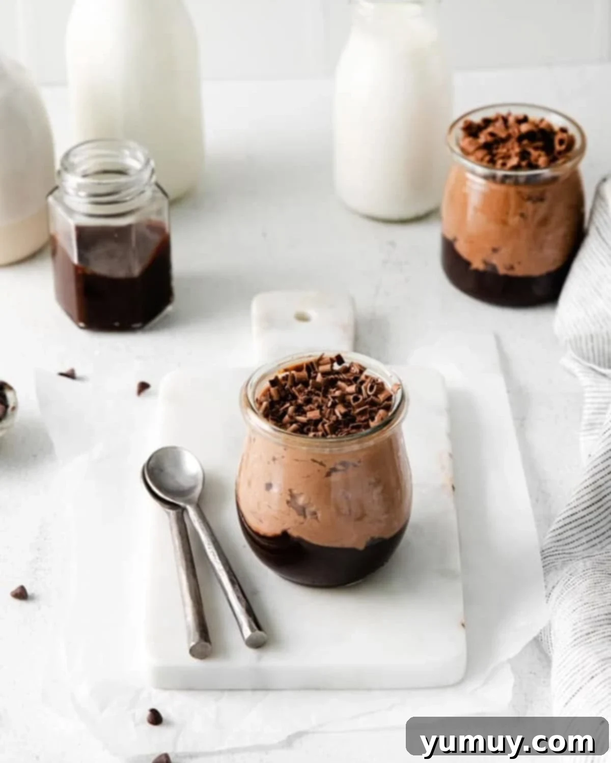 a serving of no bake chocolate cheesecake mousse in a small glass jar.