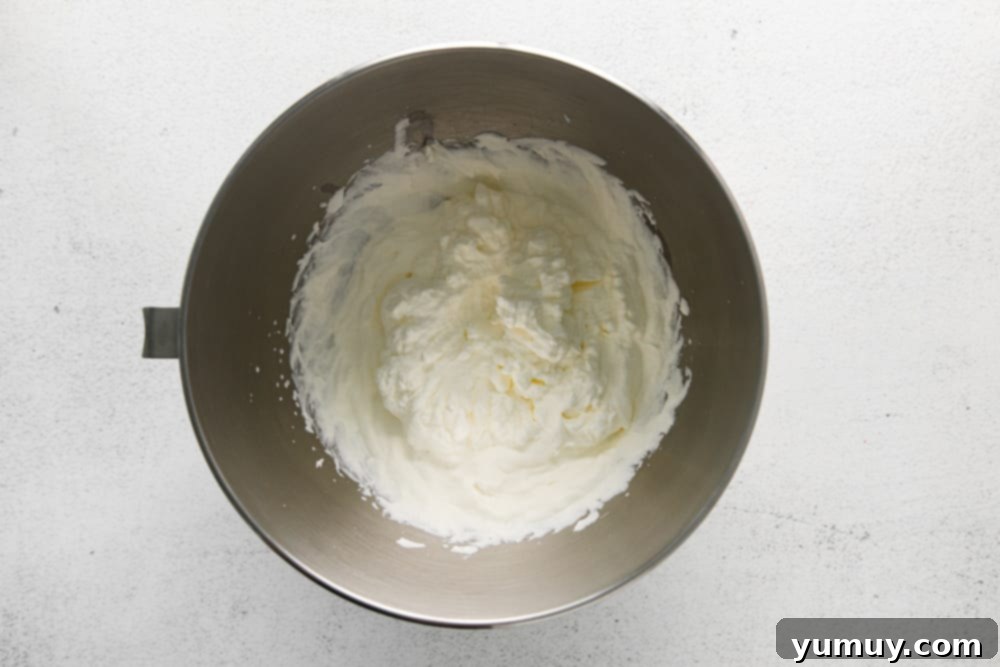 beaten whipped cream in a stainless mixing bowl.