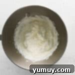 beaten whipped cream in a stainless mixing bowl.