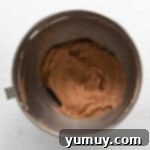 no bake chocolate cheesecake batter in a stainless mixing bowl.