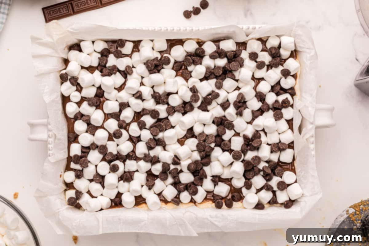 Smores Bars 20 mini marshmallows and chocolate chips in a baking pan.