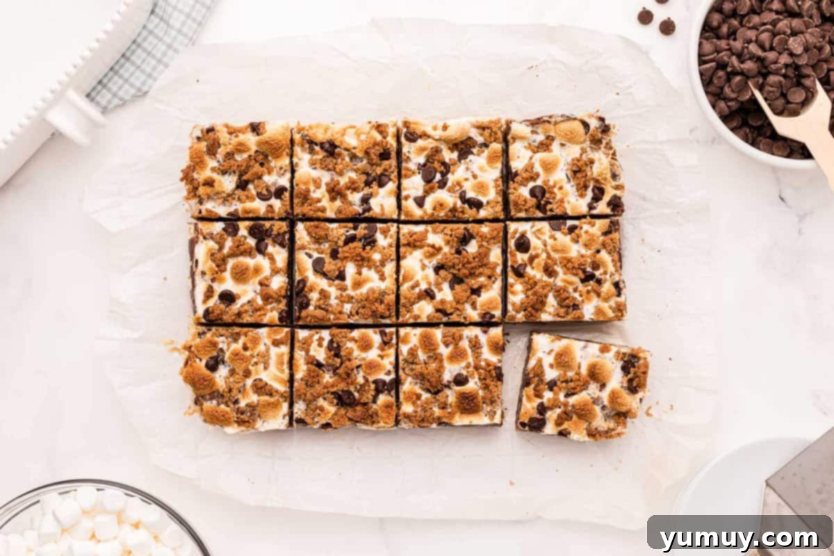 Smores Bars 3 cut s'mores bars on parchment paper.