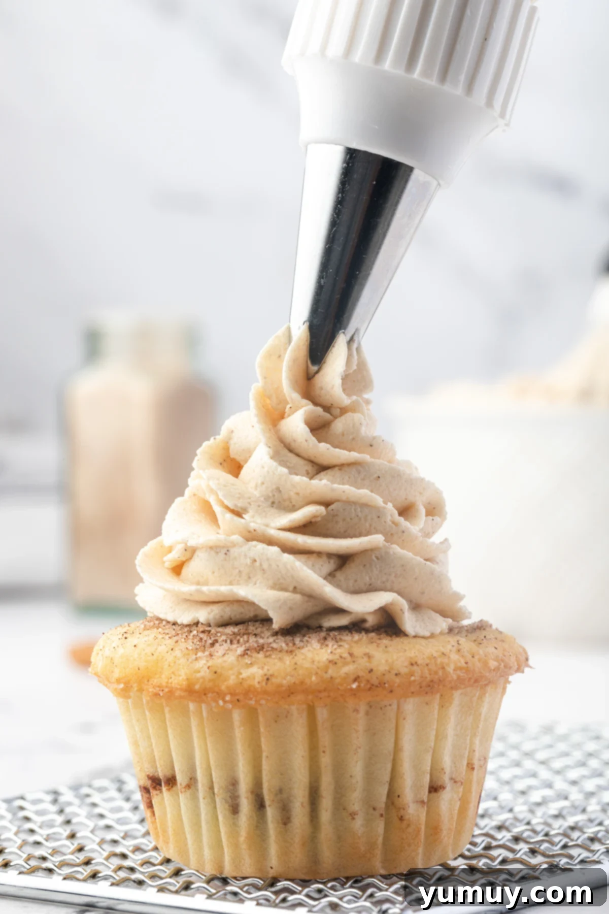 Caramelized Brown Sugar Buttercream 2 piping brown sugar buttercream onto a cupcake