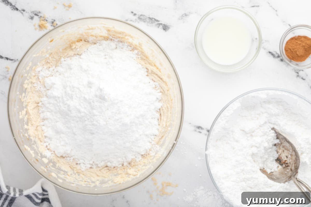 Caramelized Brown Sugar Buttercream 11 a bowl of flour, sugar, and other ingredients on a marble countertop.