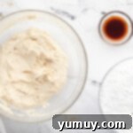 Caramelized Brown Sugar Buttercream 5 a bowl of ingredients with a spoon and a bowl of flour.