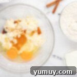 a bowl with eggs, flour, sugar and cinnamon.