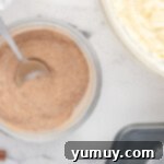 cinnamon and sugar in a bowl with a spoon.