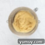 Smooth and glossy French cruller dough ready for piping.