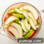 Freshly sliced apples soaking in a bowl of cold water, preventing browning.