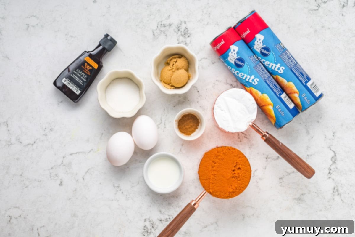 Pumpkin pie crescent roll ingredients including pumpkin puree, spices, sugars, and crescent roll dough.