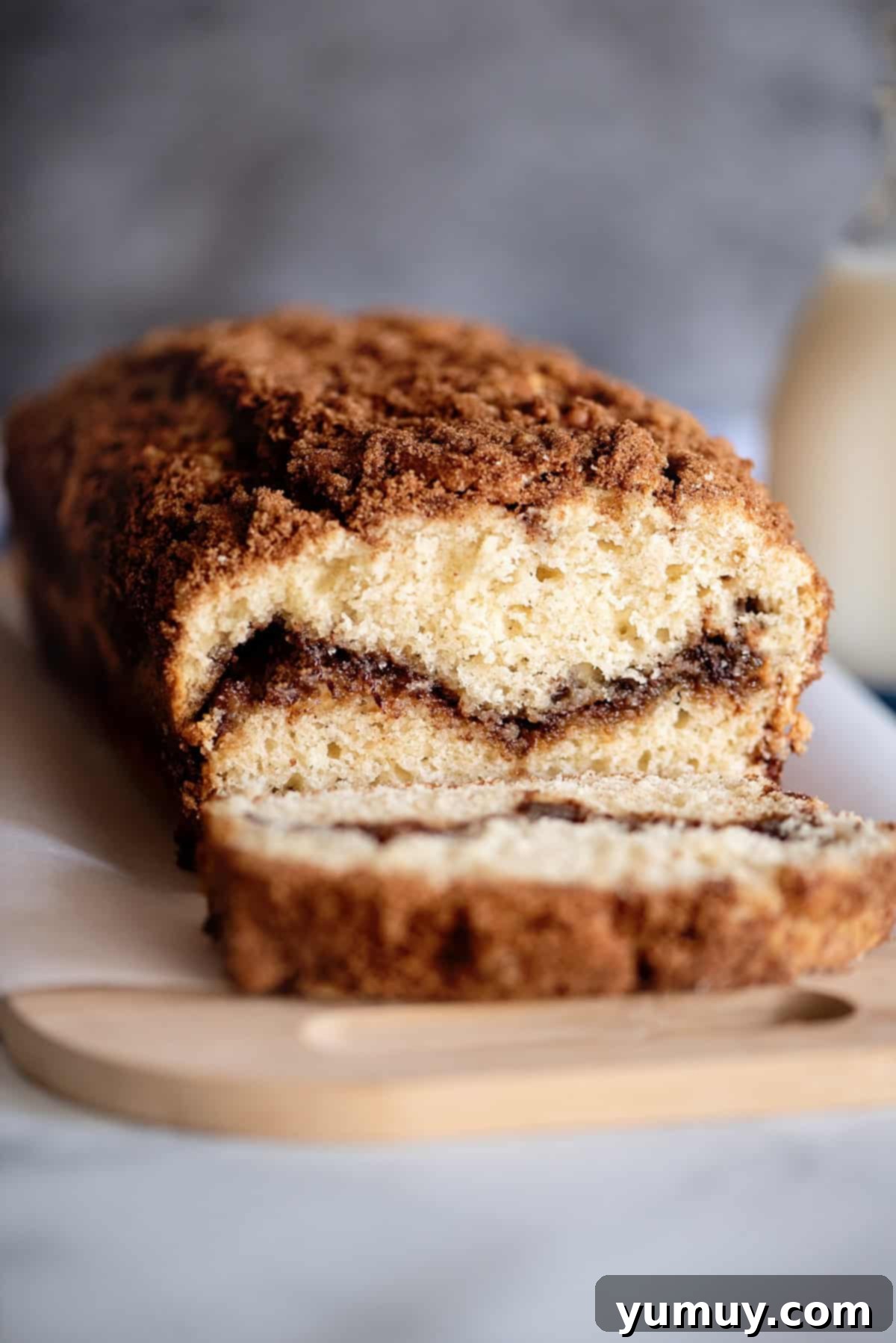 Snickerdoodle Swirl Bread 2 A loaf of freshly baked snickerdoodle bread, sliced to reveal the inviting cinnamon brown sugar filling.