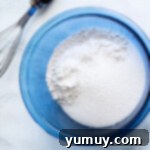 Snickerdoodle Swirl Bread 7 Dry ingredients are mixed in a bowl with a whisk.