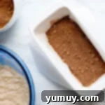 Snickerdoodle Swirl Bread 9 The layered quick bread dough in a loaf pan, with a visible cinnamon brown sugar swirl.