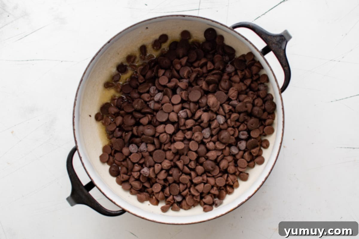 Irresistible Homemade Crunch Bars 11 Chocolate chips melting into the butter in a Dutch oven.