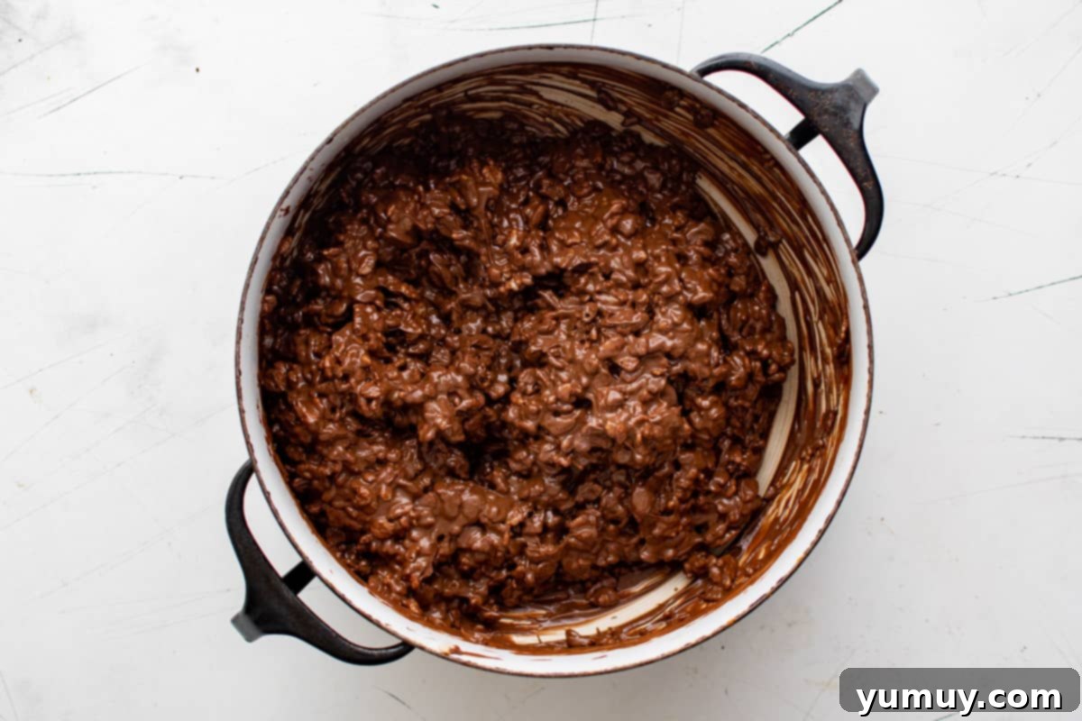 Irresistible Homemade Crunch Bars 13 Chocolate crunch mixture fully combined in a pot.