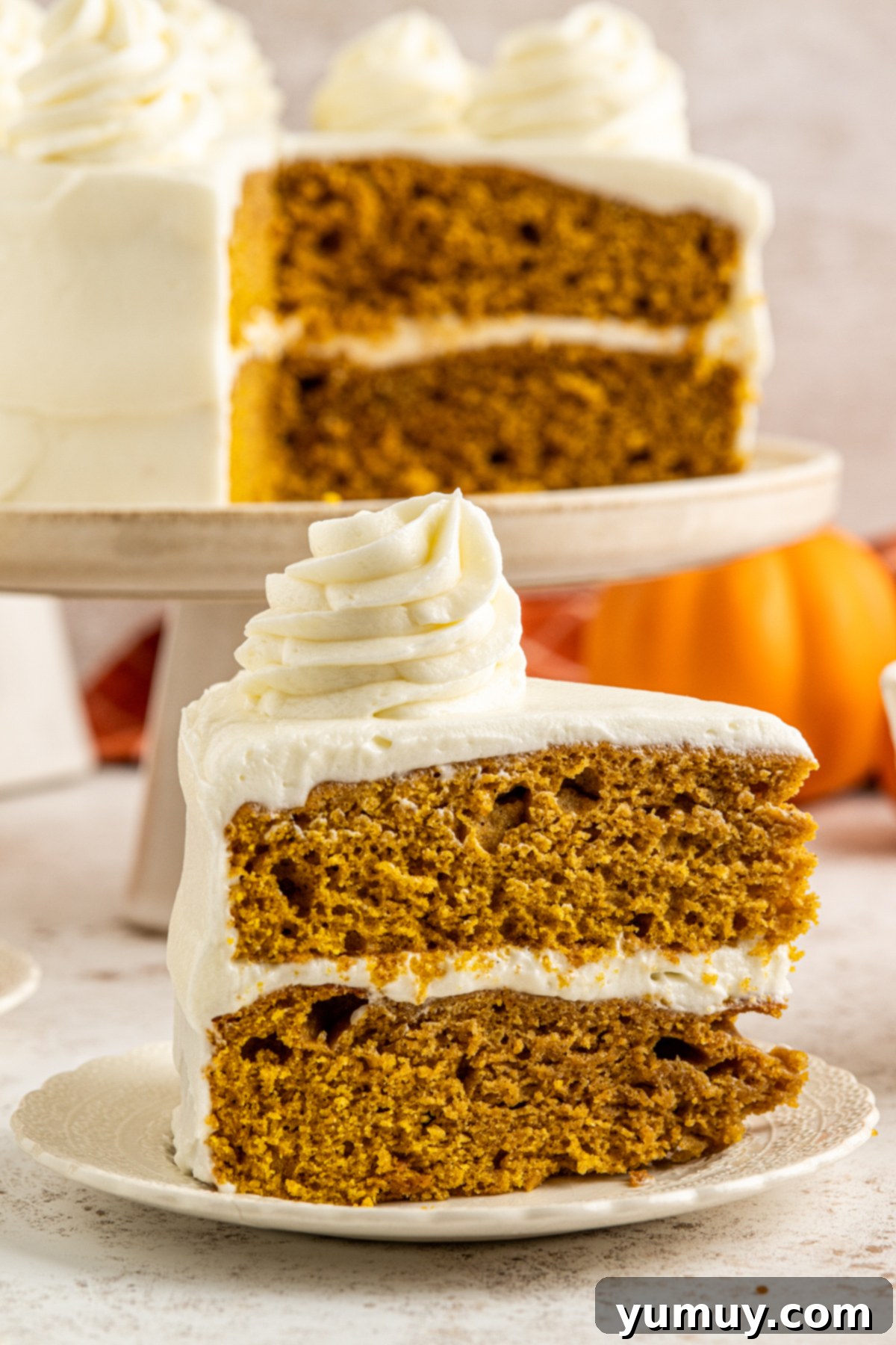 Irresistible Pumpkin Cake with Zesty Cream Cheese Frosting 2 side view of a slice of pumpkin cake with cream cheese frosting