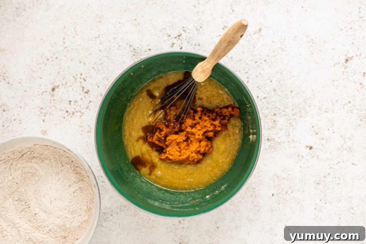 Irresistible Pumpkin Cake with Zesty Cream Cheese Frosting 13 whisking together wet ingredients
