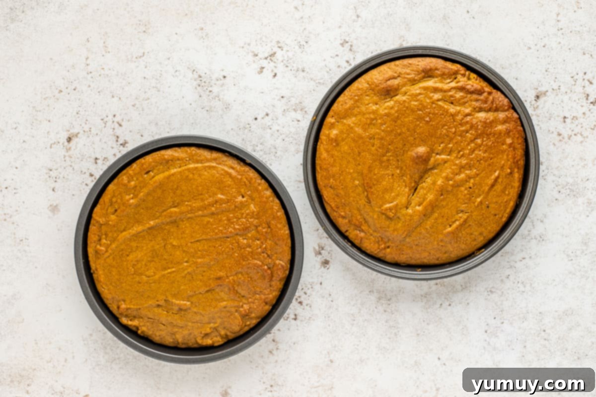 Irresistible Pumpkin Cake with Zesty Cream Cheese Frosting 15 two pumpkin cakes in round cake pans