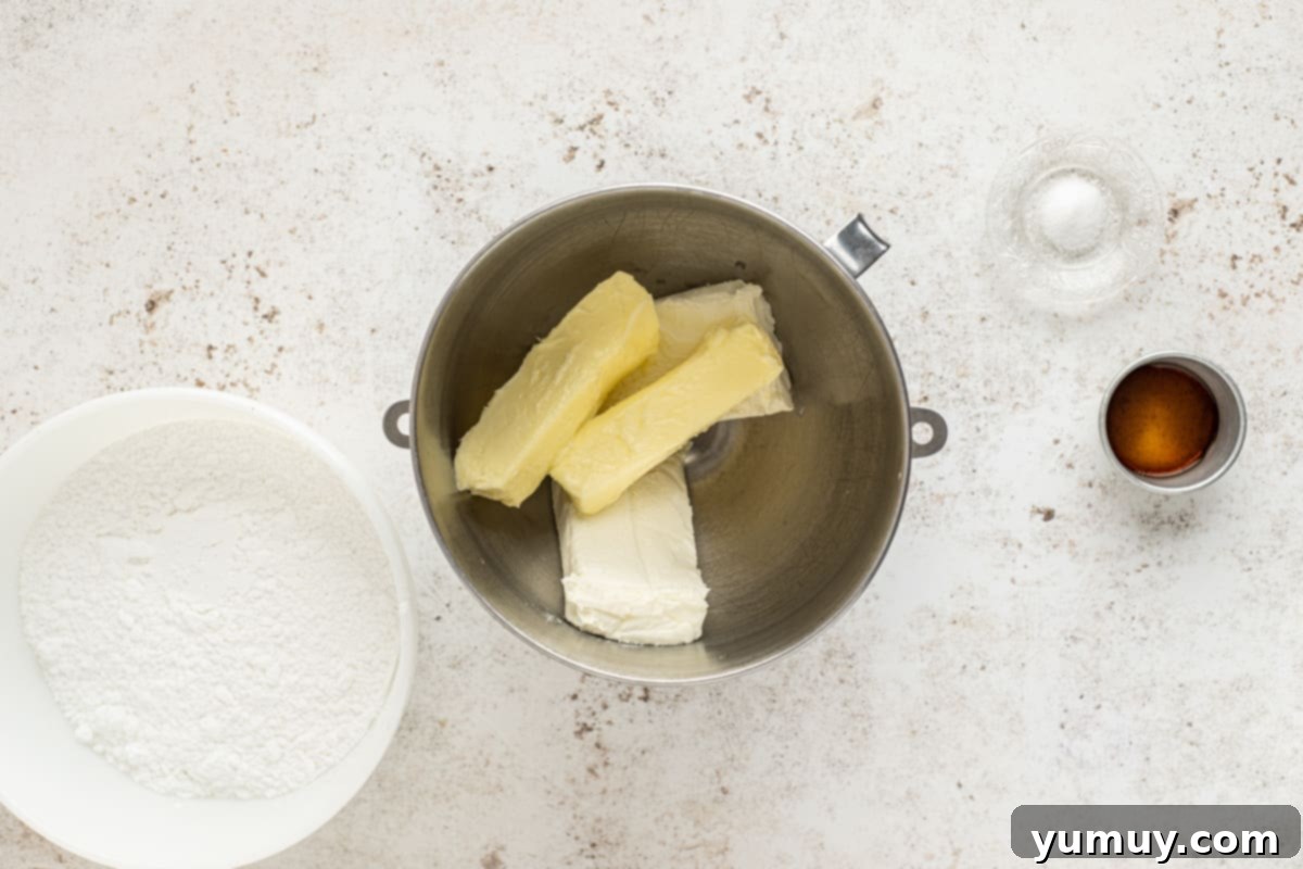 Irresistible Pumpkin Cake with Zesty Cream Cheese Frosting 16 butter and cream cheese in a mixing bowl