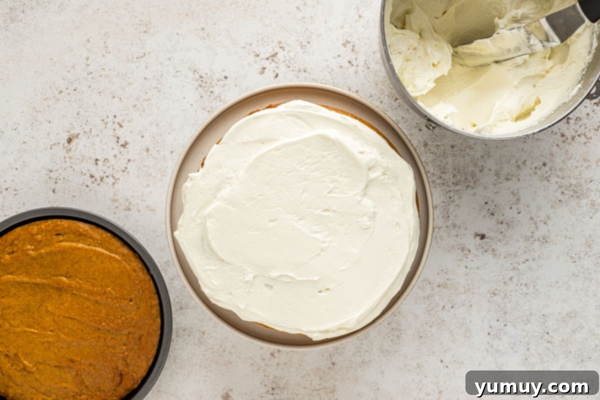 Irresistible Pumpkin Cake with Zesty Cream Cheese Frosting 19 spreading frosting onto a cake layer