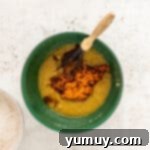 Irresistible Pumpkin Cake with Zesty Cream Cheese Frosting 5 whisking together wet ingredients