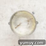 Irresistible Pumpkin Cake with Zesty Cream Cheese Frosting 9 flour in a metal bowl on a white background.