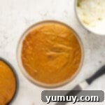 Irresistible Pumpkin Cake with Zesty Cream Cheese Frosting 10 round pumpkin cake layer on a cake stand