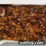 a baking sheet filled with candy and pretzels.