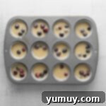 Tangy Cranberry Delights 10 Cupcake tin filled with batter ready for baking.