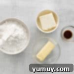 Cream cheese and butter in a stand mixer bowl, ready to be beaten for frosting.