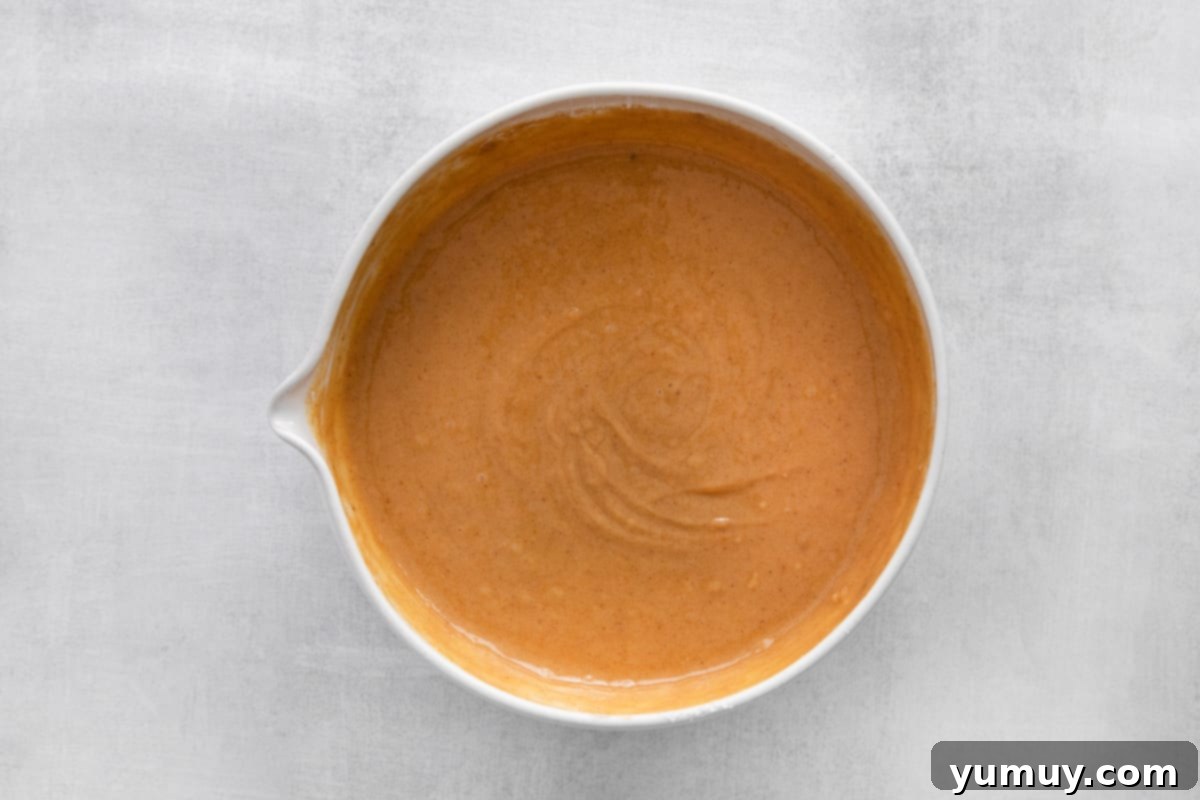 Smooth, well-combined cupcake batter in a large mixing bowl, ready for portioning.