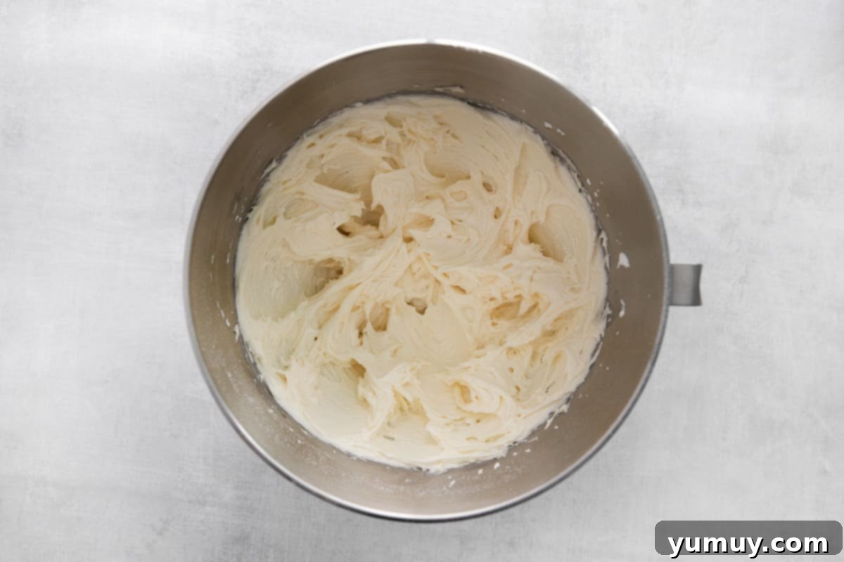 Fluffy cream cheese frosting in a mixing bowl after all ingredients have been thoroughly combined.