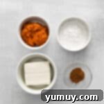 Ingredients for the pumpkin pie filling placed in a mixing bowl.