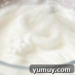 Golden Butterscotch Delight 11 Firmly whipped egg whites forming stiff peaks in a mixing bowl.