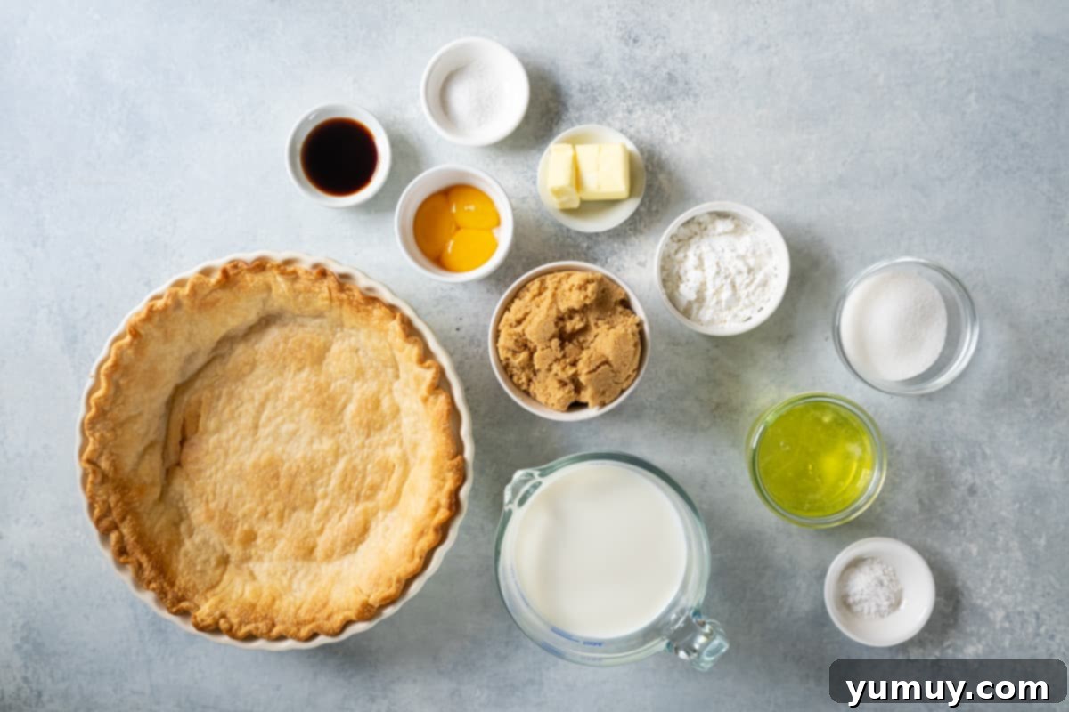 Golden Butterscotch Delight 16 All ingredients for butterscotch pie laid out: pre-baked pie crust, separated egg yolks and whites, brown sugar, cornstarch, butter, vanilla extract, and milk.